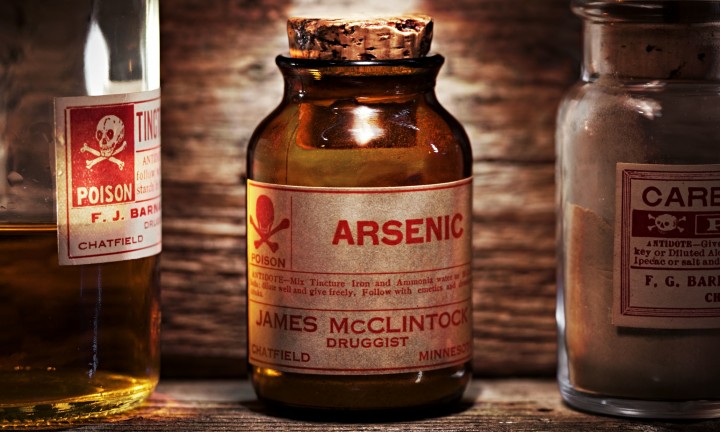 Vintage arsenic poison bottle on antique shelf